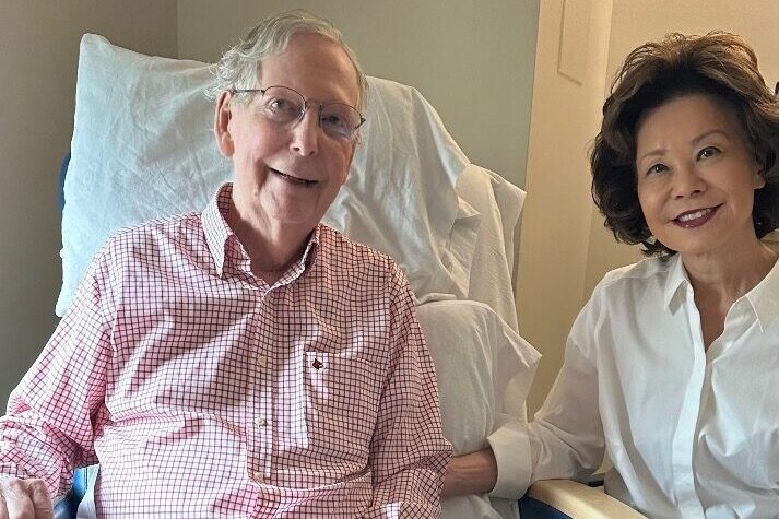 Mitch McConnell seated in a hospital room beside Elaine Chao in a photo released by his office